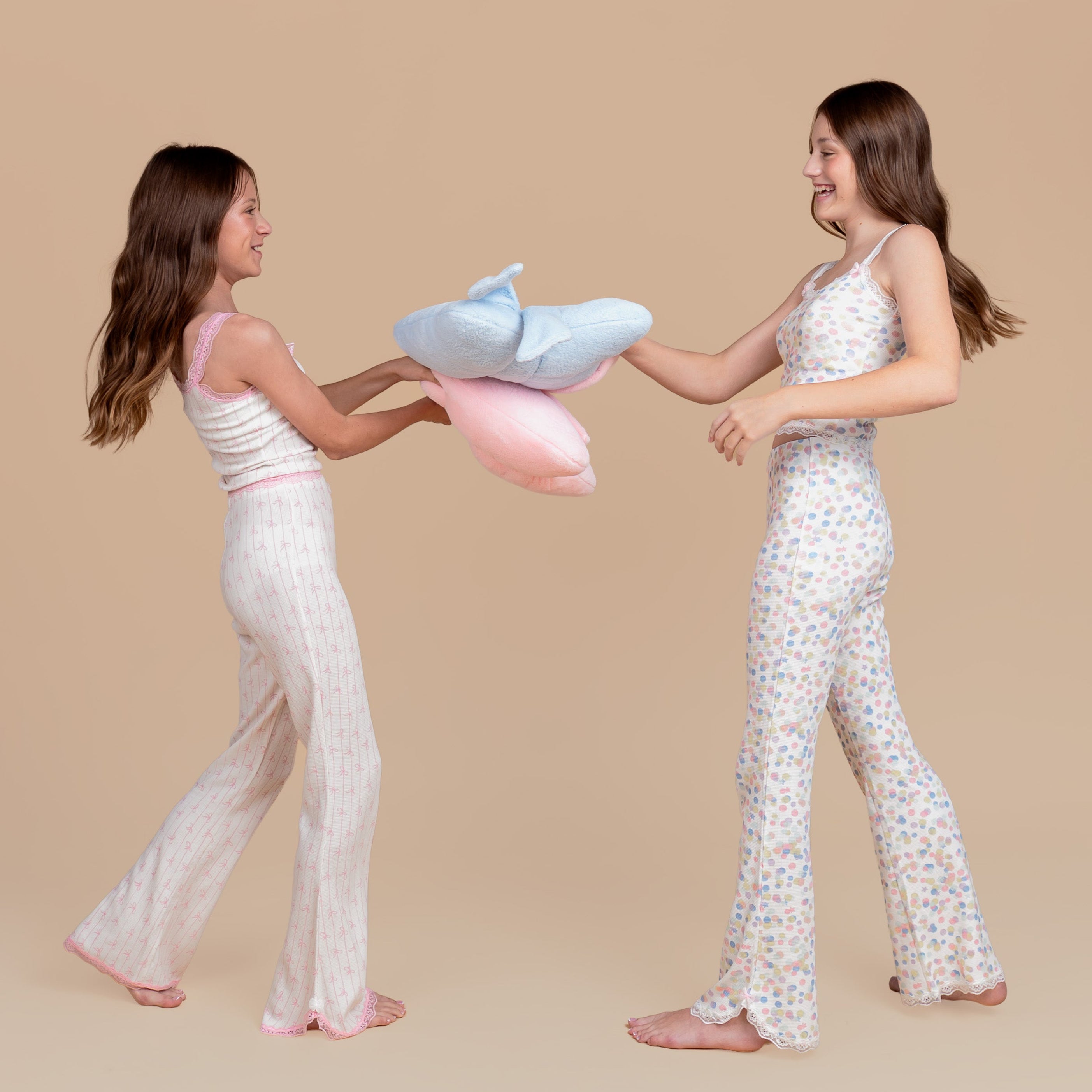 Tween and teen models in Dream Queen Co. in It's a Vibe lounge set, pink bow stripe and confetti pastel print