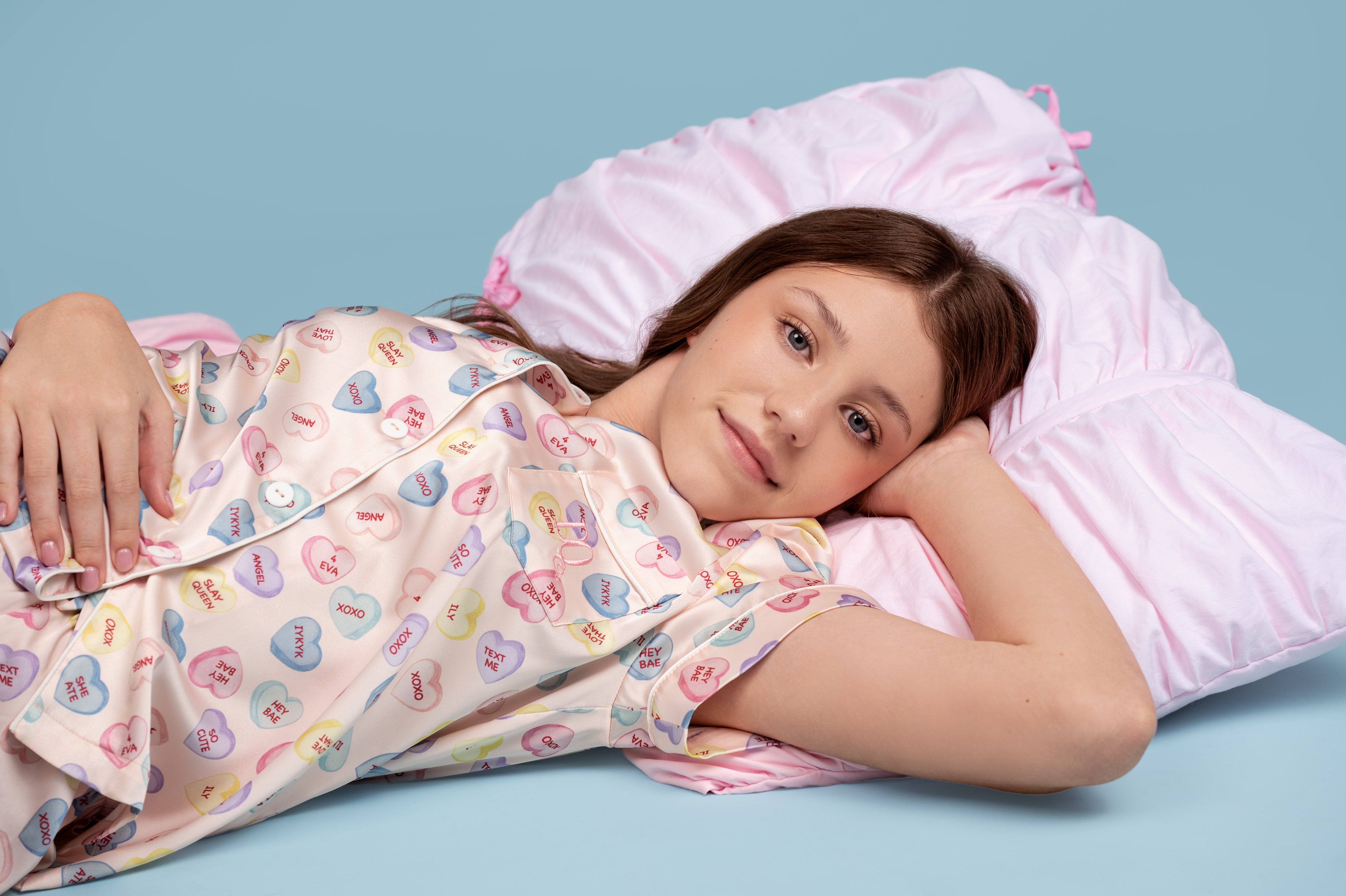 Model in Dream Queen Co. in Conversation hearts, pastel satin PJ set
