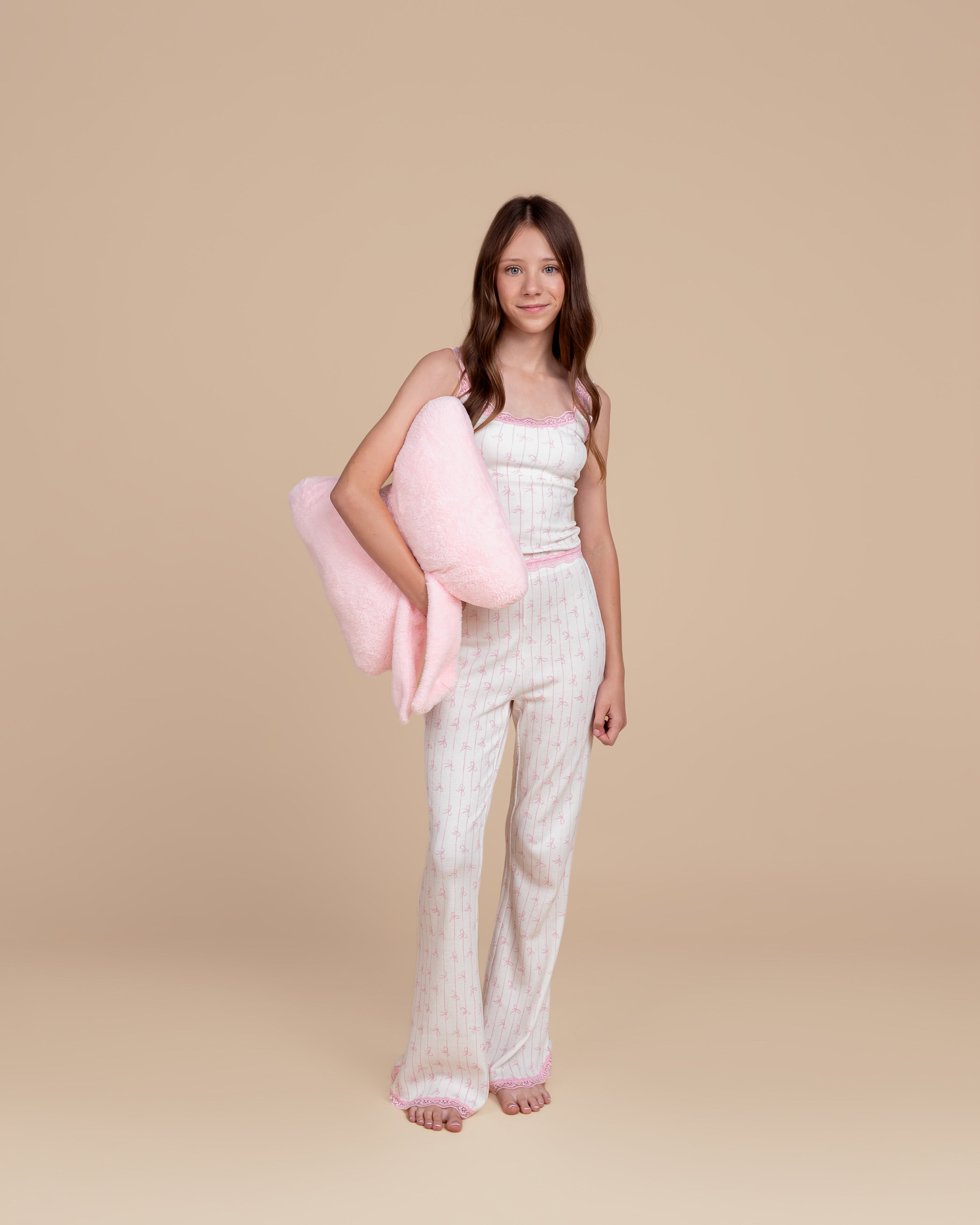 Tween model wearing Dream Queen Co. Love Lines waffle lounge set in pink bow stripe