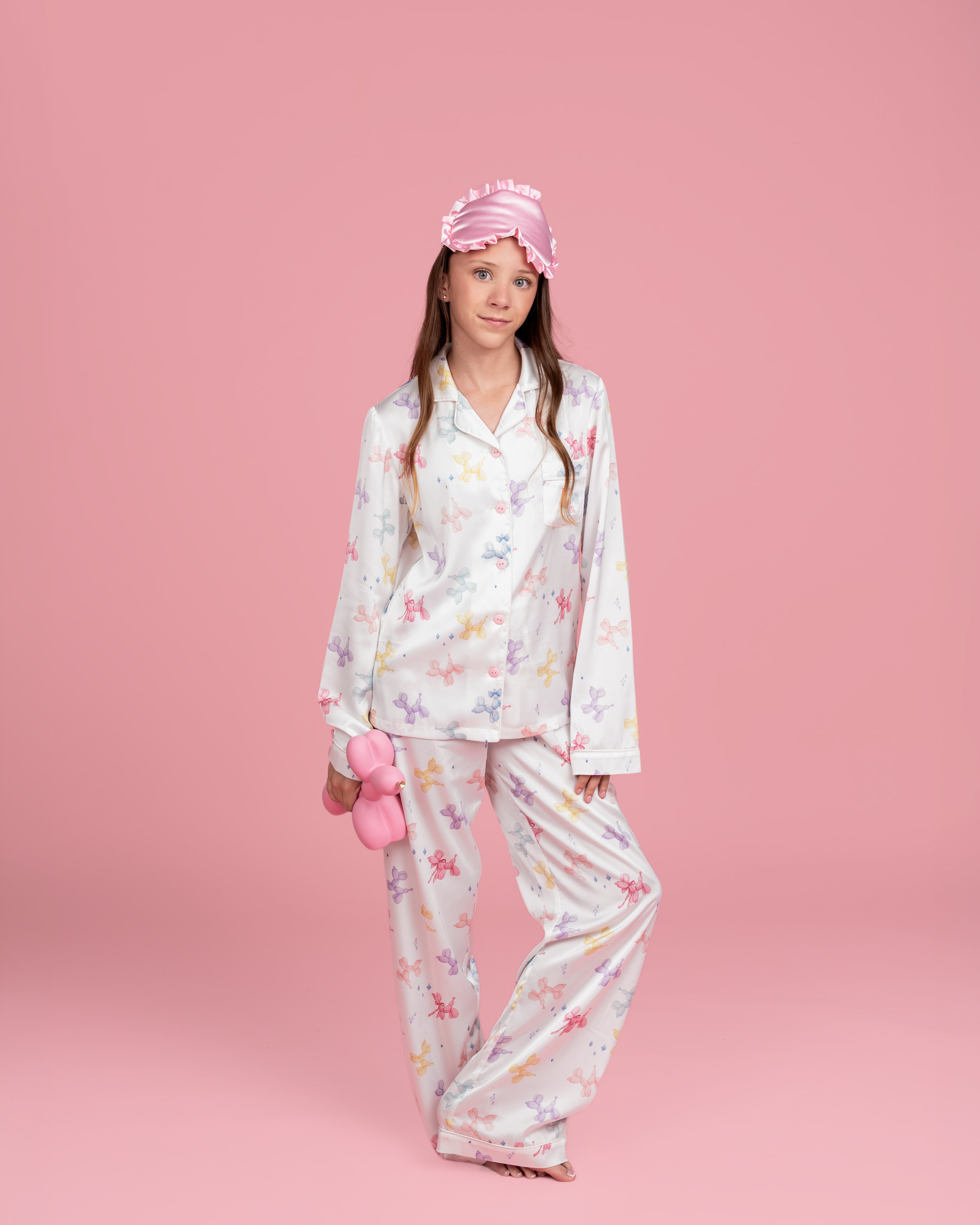 Tween model wearing Dream Queen Co. Sleep Cute Long sleeve satin PJ set in Sugar Pups Balloon Dog pastel Print