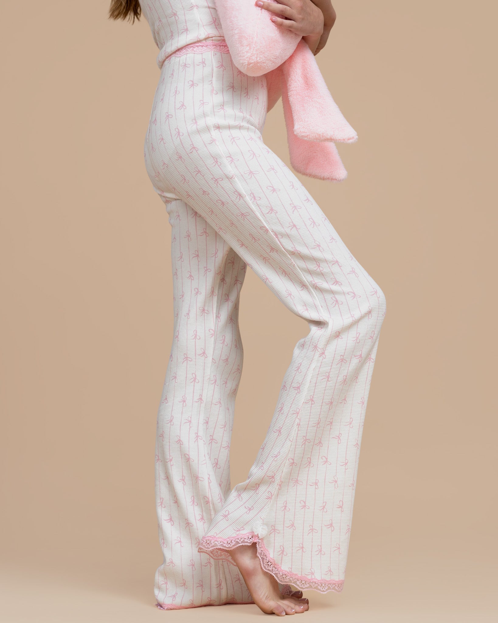 Model wearing Dream Queen Co. Love Lines waffle lounge set in pink bow stripe