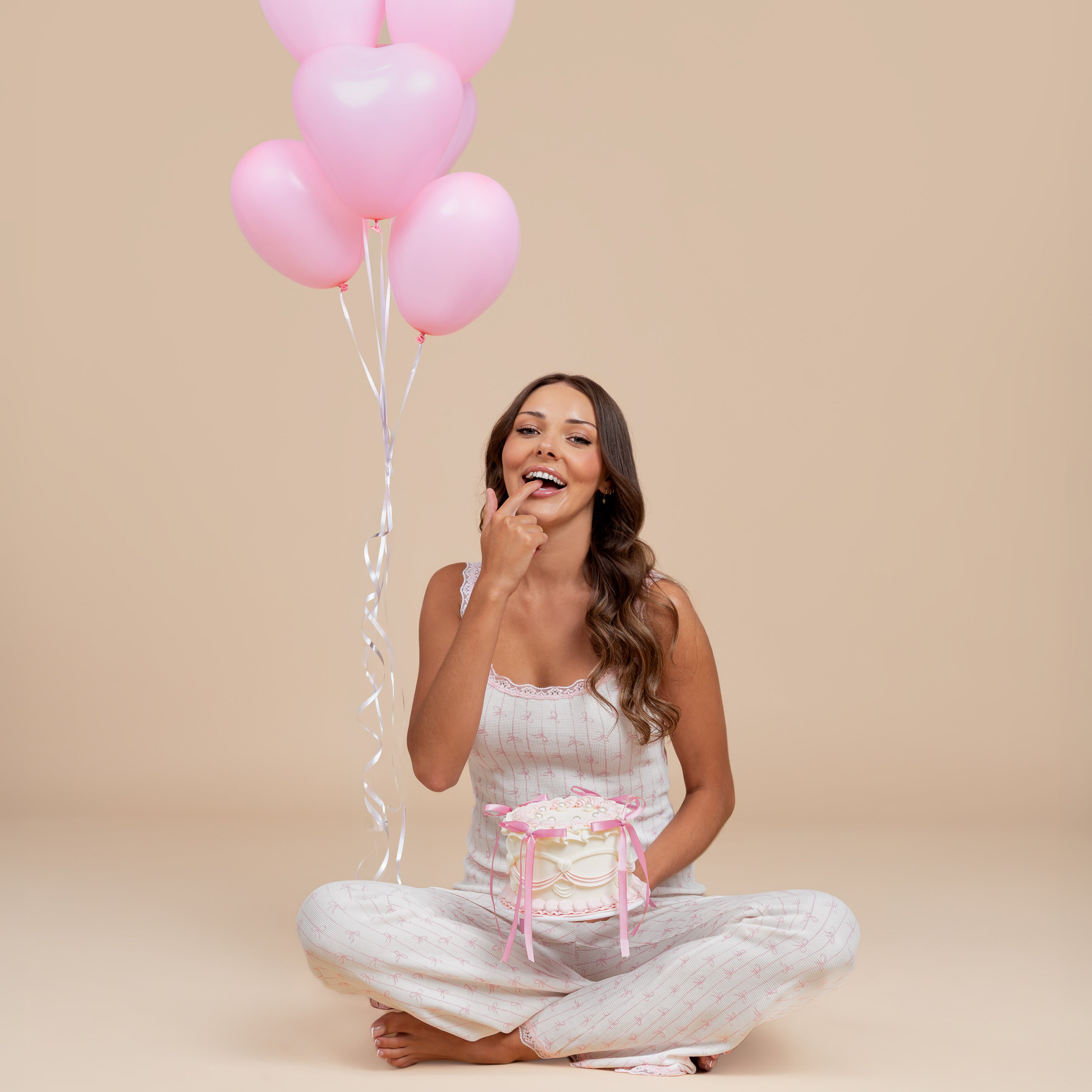 Model in Dream Queen Co. It's a Vibe lounge set in pink bow stripe